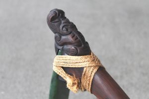 Carved detail on traditional Maori adze with greenstone head by Al Brown