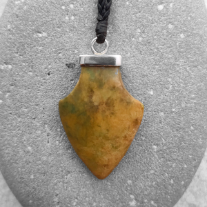 Spearhead pendant carved from yellow green NZ jade, by Ana Krakosky