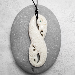 Carved beef bone manaia pendant