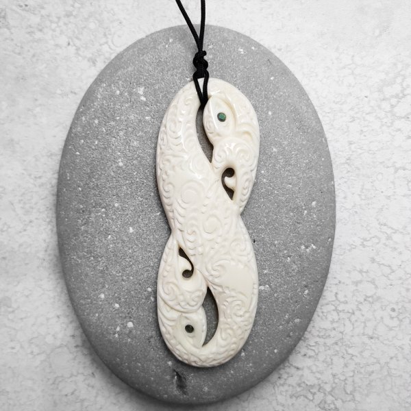 Carved beef bone manaia pendant