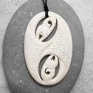 Carved beef bone manaia pendant