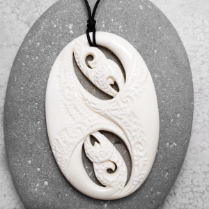 Carved beef bone manaia pendant