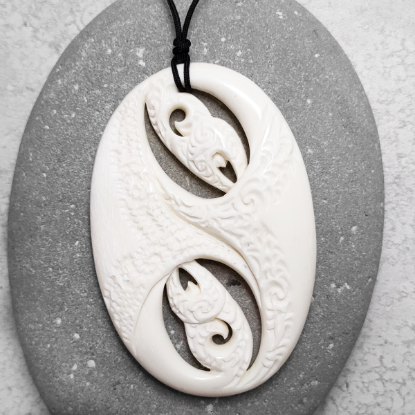 Carved beef bone manaia pendant