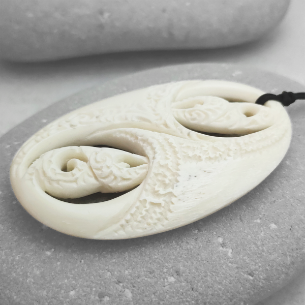 Carved beef bone manaia pendant