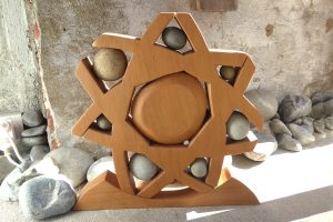 Wood & stone sculpture called 'Wheel of Life' by Peter Radley