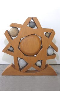 Wood & stone sculpture called 'Wheel of Life' by Peter Radley