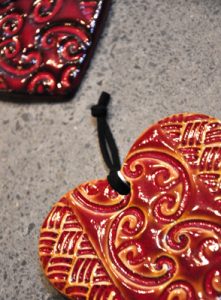 Small ceramic hearts with red glaze by Michelle Bow